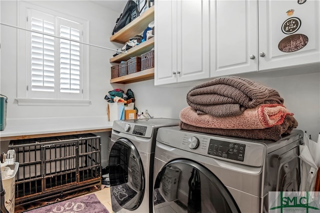 laundry room featuring independent washer and dryer and cabinets