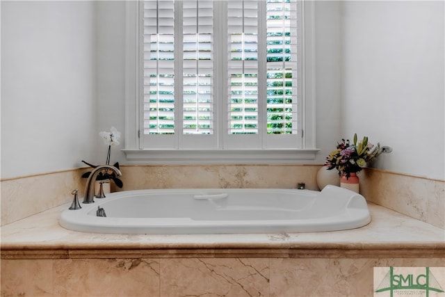 bathroom with plenty of natural light and a bathing tub