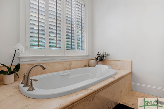 bathroom with tile floors and tiled tub