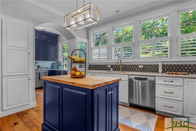 kitchen with tasteful backsplash, dishwasher, blue cabinetry, and sink