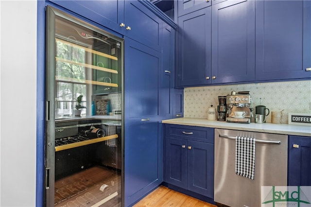 kitchen with backsplash, blue cabinets, light hardwood / wood-style floors, and dishwasher