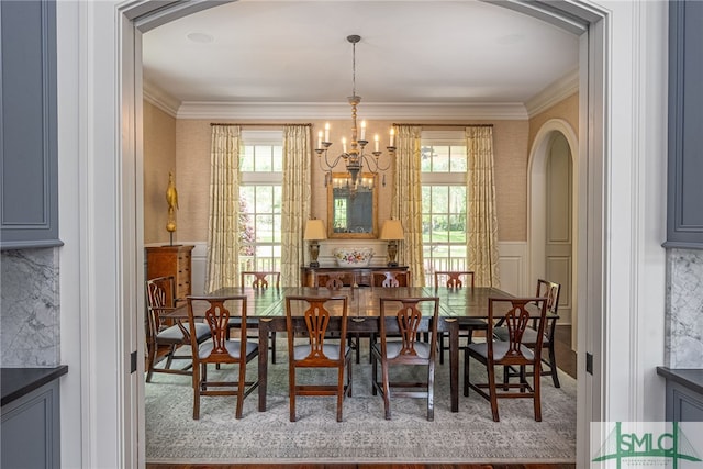 dining area featuring an inviting chandelier and ornamental molding