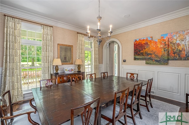 dining space featuring a notable chandelier, hardwood / wood-style flooring, and crown molding