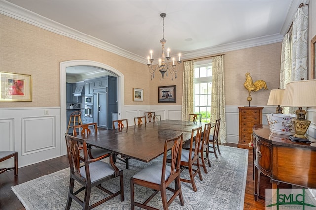 dining space with dark hardwood / wood-style flooring, a chandelier, and crown molding