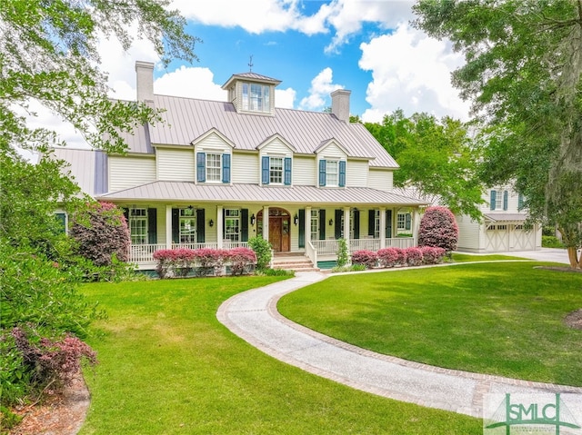 view of front of house with a front lawn, a garage, and covered porch