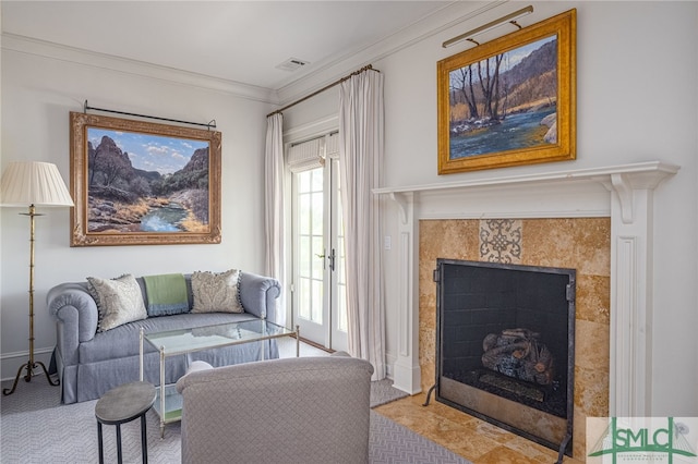 living room featuring a healthy amount of sunlight, carpet, ornamental molding, and a fireplace