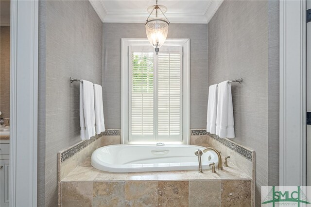 bathroom with tiled bath and ornamental molding