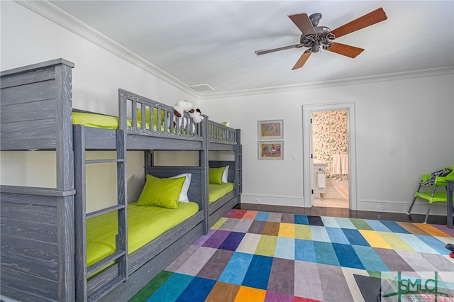 unfurnished bedroom featuring dark wood-type flooring, ensuite bath, and crown molding