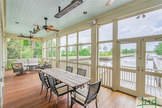 sunroom with plenty of natural light, ceiling fan, and french doors