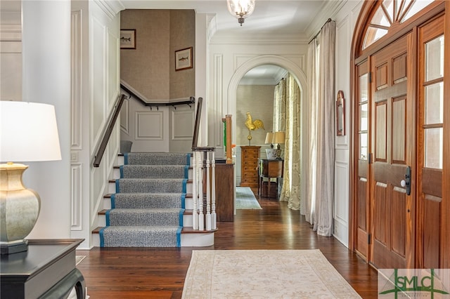 entrance foyer featuring crown molding and dark hardwood / wood-style floors