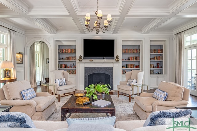 living room with wood-type flooring, built in features, and coffered ceiling