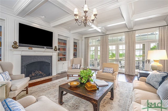 living room featuring a notable chandelier, hardwood / wood-style floors, coffered ceiling, and french doors