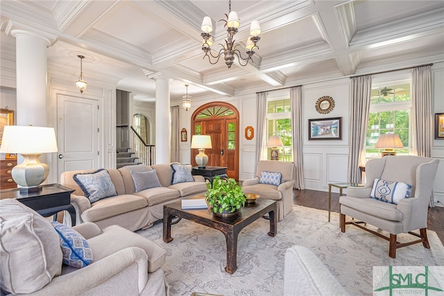 living room with decorative columns, coffered ceiling, plenty of natural light, and hardwood / wood-style floors