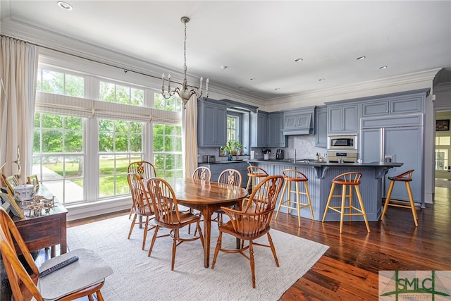 dining room featuring ornamental molding and hardwood / wood-style flooring