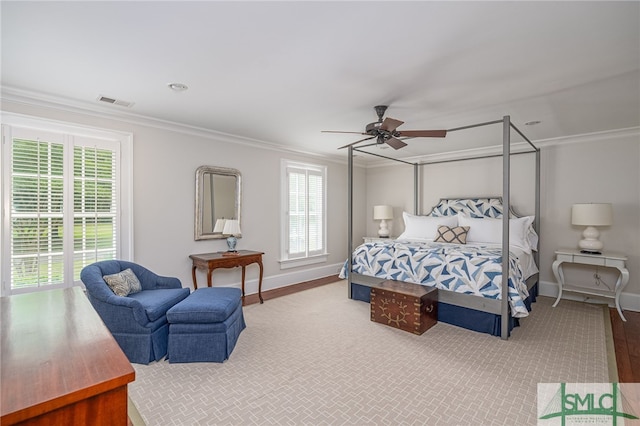 bedroom featuring ceiling fan, ornamental molding, and hardwood / wood-style flooring