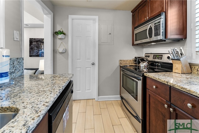 kitchen featuring light stone counters and appliances with stainless steel finishes