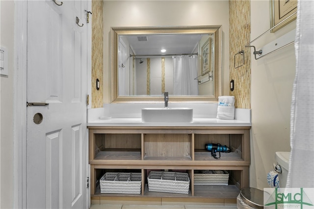 bathroom featuring toilet and large vanity