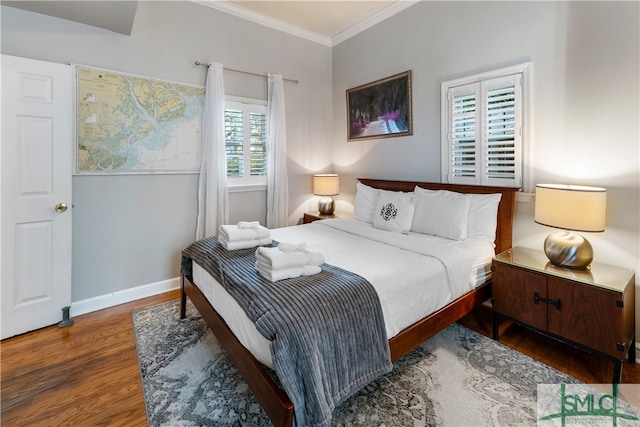 bedroom featuring ornamental molding and dark wood-type flooring