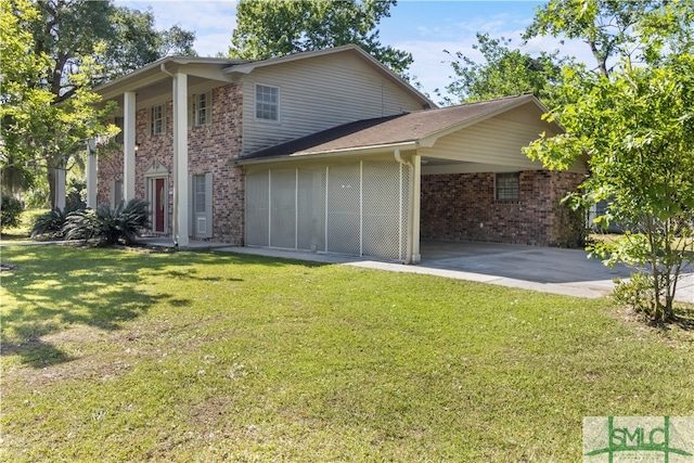 rear view of property with a carport and a lawn