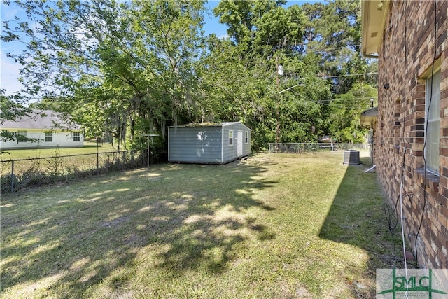 view of yard featuring central AC unit and a storage shed