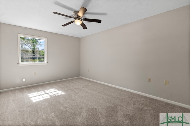 empty room with ceiling fan and light colored carpet