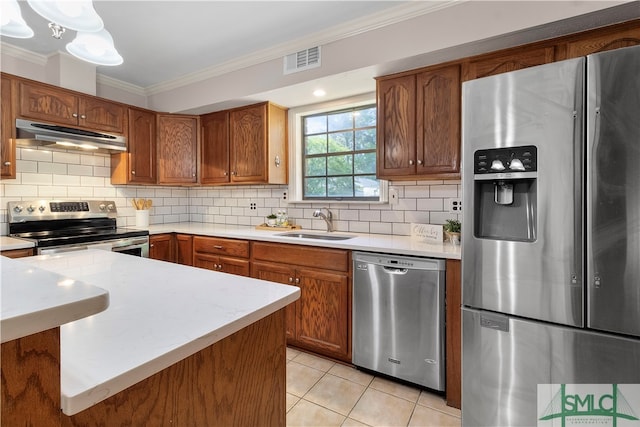 kitchen featuring decorative backsplash, appliances with stainless steel finishes, crown molding, sink, and light tile patterned floors