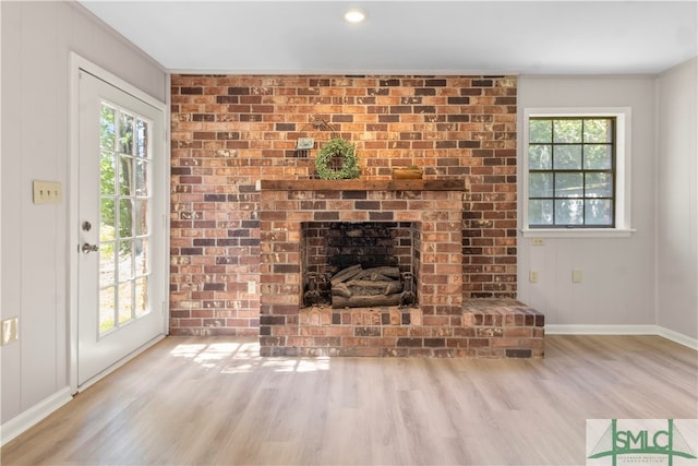 unfurnished living room with plenty of natural light and light hardwood / wood-style floors