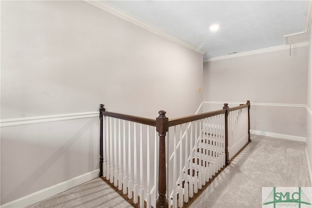 stairs featuring crown molding and carpet floors