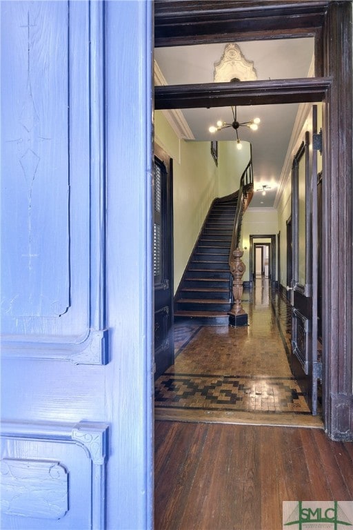 foyer entrance featuring hardwood / wood-style floors and ornamental molding