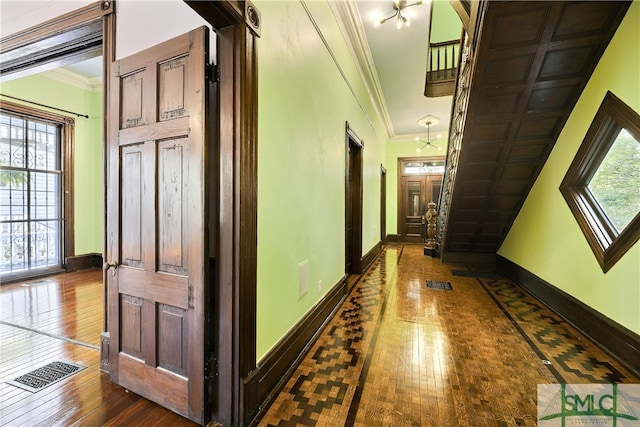 hall featuring hardwood / wood-style floors, plenty of natural light, and ornamental molding