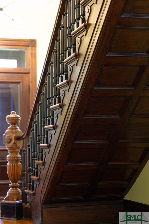 stairs featuring coffered ceiling