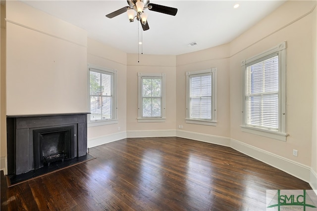 unfurnished living room featuring dark hardwood / wood-style flooring and ceiling fan