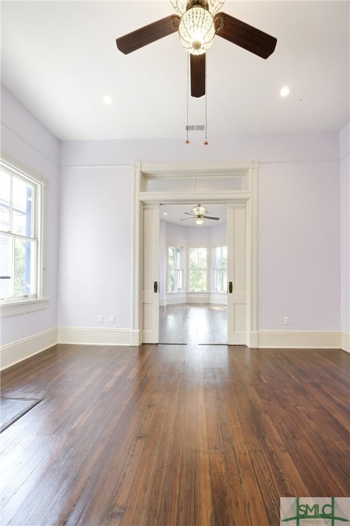 unfurnished living room with a healthy amount of sunlight, dark hardwood / wood-style flooring, and ceiling fan