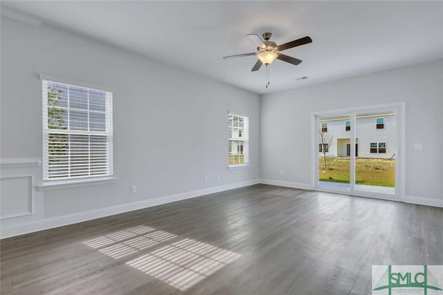 empty room with dark hardwood / wood-style floors and ceiling fan