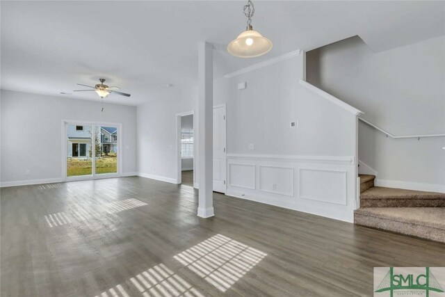 unfurnished living room featuring ornamental molding, ceiling fan, and dark hardwood / wood-style floors