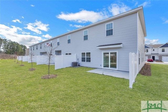 rear view of house featuring a patio area, a yard, and central air condition unit