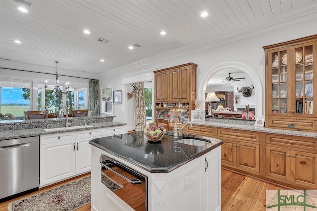 kitchen with light hardwood / wood-style floors, light stone countertops, ceiling fan with notable chandelier, stainless steel dishwasher, and sink