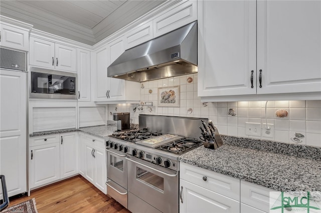 kitchen with light hardwood / wood-style flooring, crown molding, tasteful backsplash, built in appliances, and white cabinets