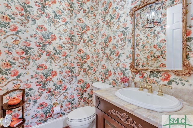 bathroom featuring oversized vanity and toilet