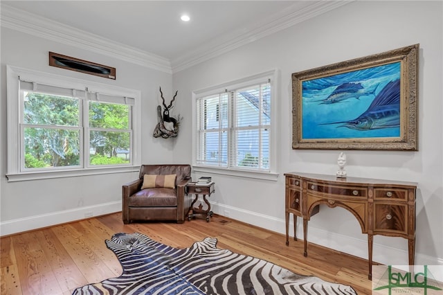 sitting room featuring ornamental molding, a wealth of natural light, and wood-type flooring