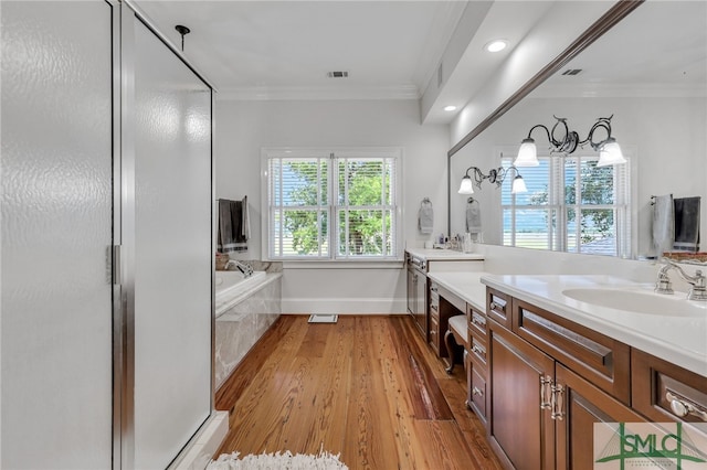 bathroom featuring double vanity, separate shower and tub, hardwood / wood-style flooring, and crown molding