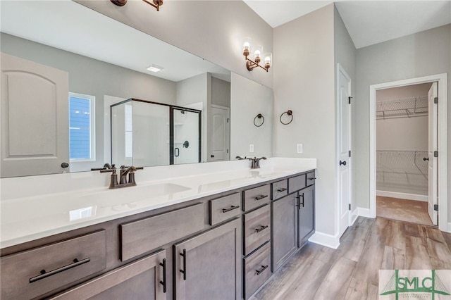 bathroom featuring vanity, hardwood / wood-style floors, and an enclosed shower