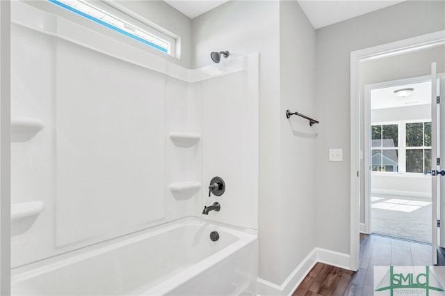 bathroom with wood-type flooring and shower / bathtub combination