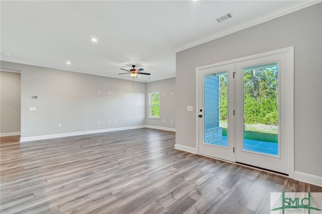 interior space with crown molding, light hardwood / wood-style flooring, and ceiling fan