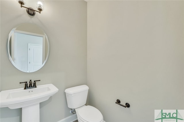 bathroom featuring toilet and sink