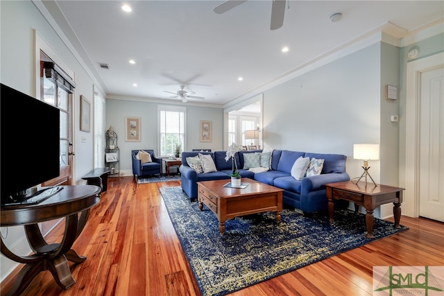 living room featuring crown molding, hardwood / wood-style flooring, and ceiling fan