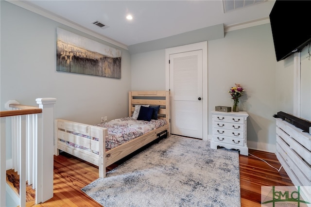 bedroom featuring hardwood / wood-style floors and a closet