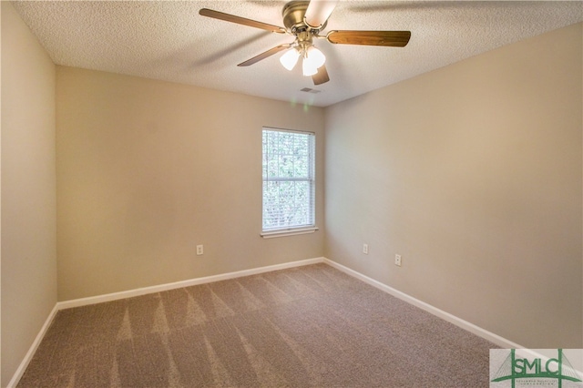 carpeted spare room featuring ceiling fan and a textured ceiling