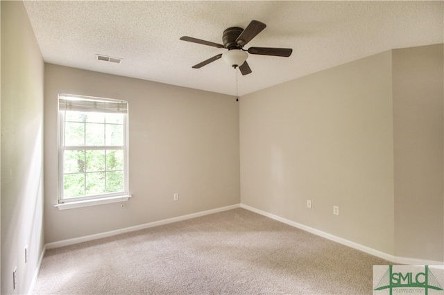 carpeted empty room with a textured ceiling and ceiling fan