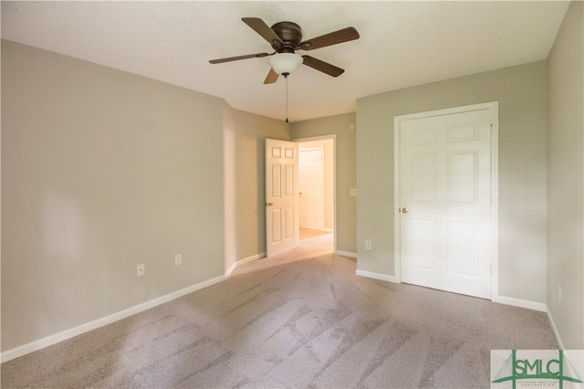 unfurnished bedroom featuring ceiling fan and carpet floors